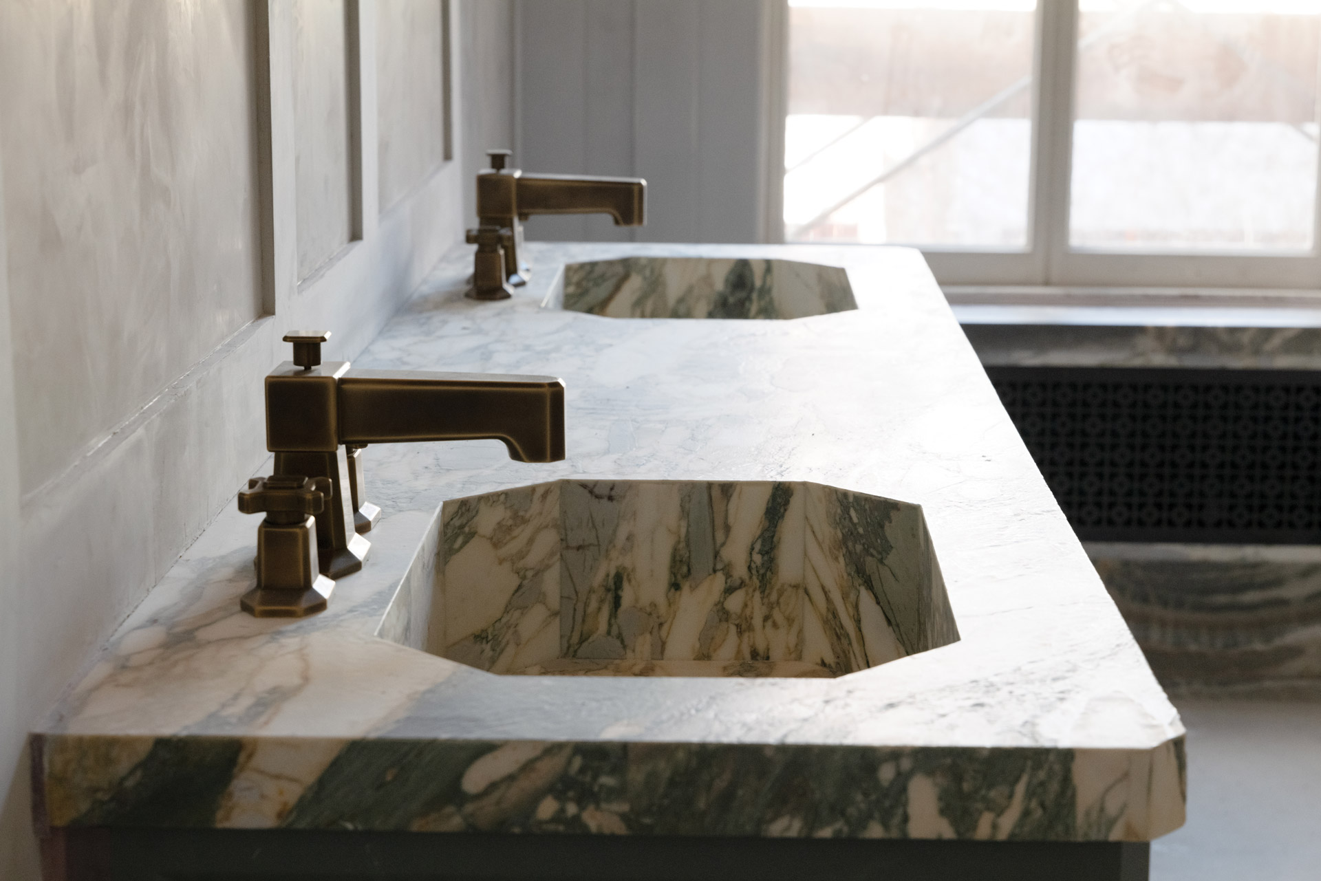 Twin octagonal sinks in the main bathroom that appear carved from a solid block were masterfully pieced together.