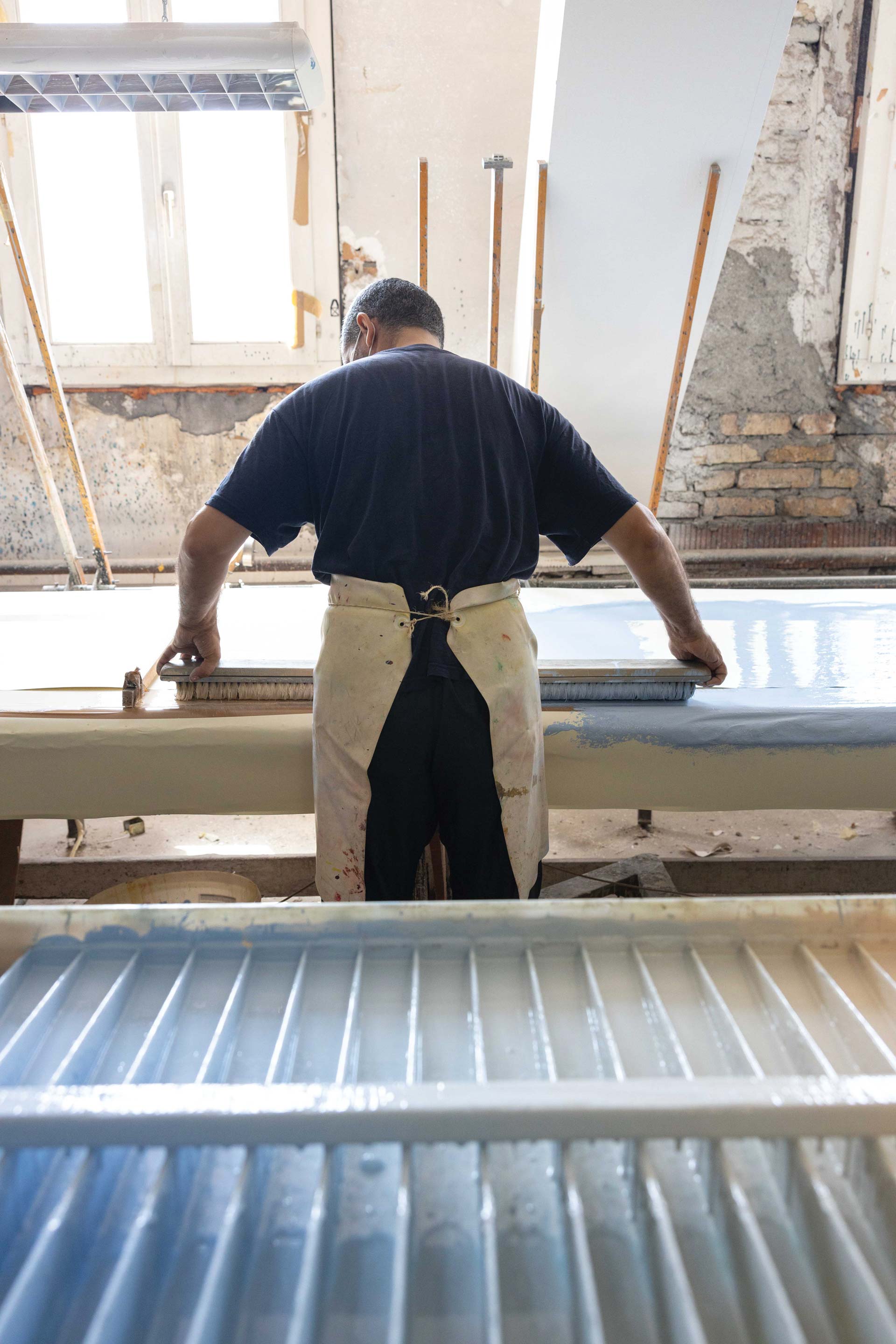 An artisan preparing panels.